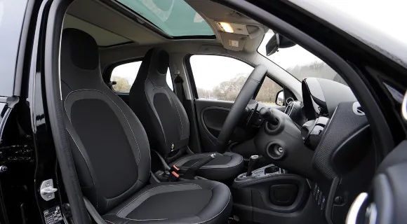 A close up of a car's interiors, including black seats
