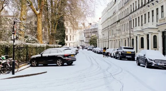Cars parked in a snowy street in London