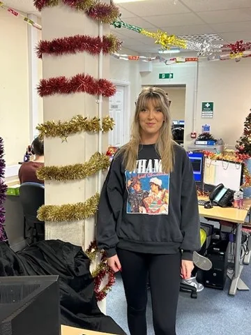 Our team member showcasing their Wham! Christmas sweater