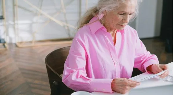 A mature woman reading a letter