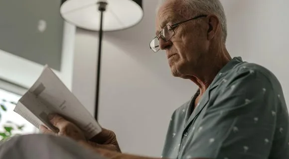 An older gentleman reading a letter